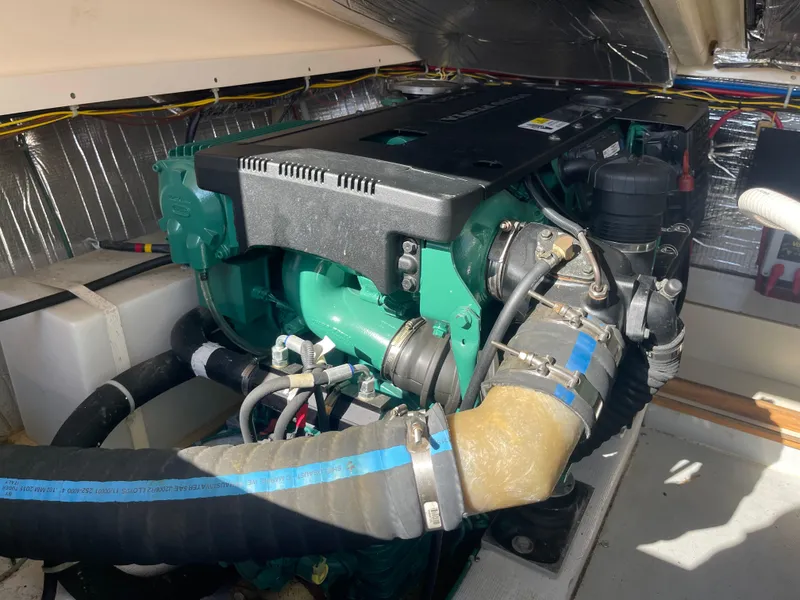 Slide: The Image of Engine compartment of a 2015 Fortier 30 boat, featuring a well-maintained marine engine. - 28