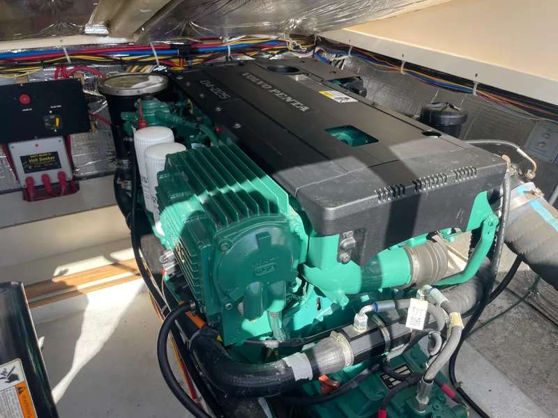 Slide: The Image of Engine compartment of a 2015 Fortier 30 boat, featuring a Volvo Penta engine. - 32