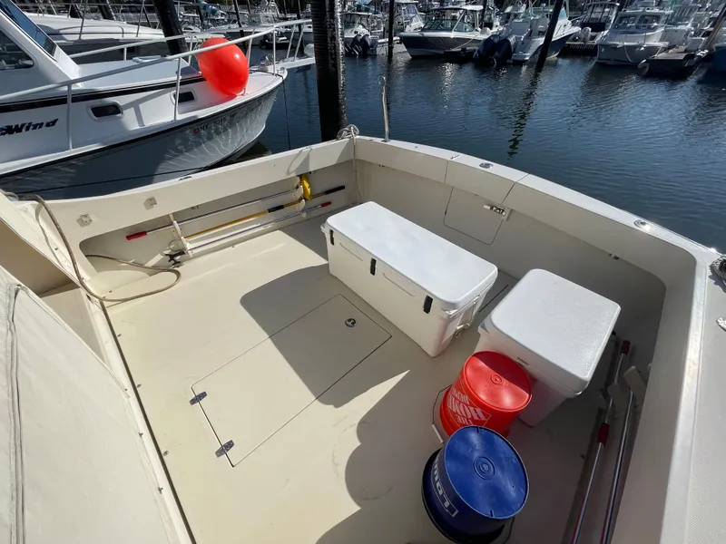 Slide: The Image of Fortier 30 boat deck with storage boxes and buckets, docked at marina, 2015 model. - 38