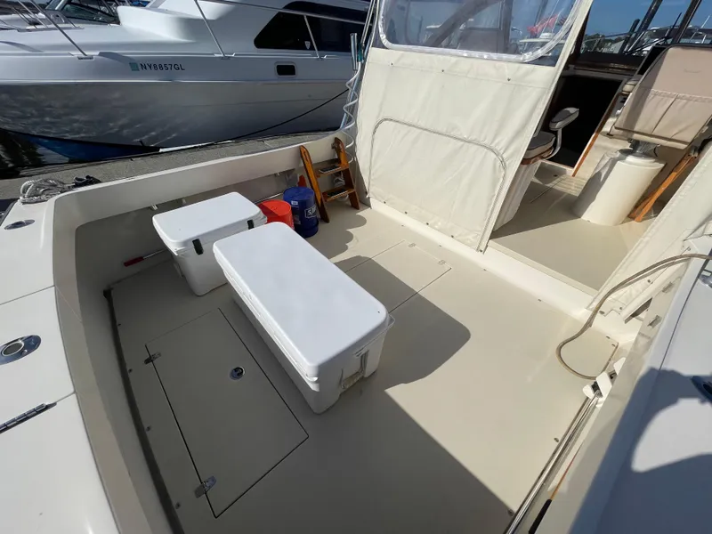 Slide: The Image of 2015 Fortier 30 boat deck with storage compartments and seating area. - 39