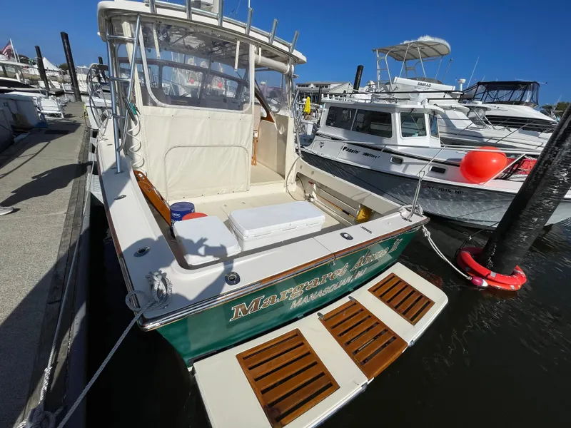 Slide: The Image of Fortier 30 boat, 2015 model, docked at marina with other vessels, sunny day. - 4