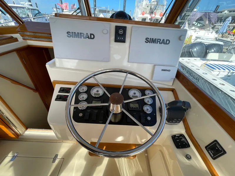 Slide: The Image of Helm of 2015 Fortier 30 boat with Simrad navigation system and steering wheel. - 9