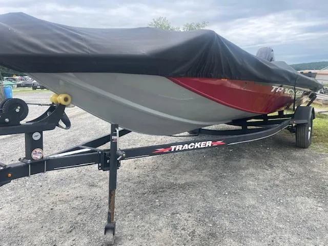Slide: The Image of 2023 Tracker Pro Team 175 TXW boat on trailer, covered, parked on gravel. - 6