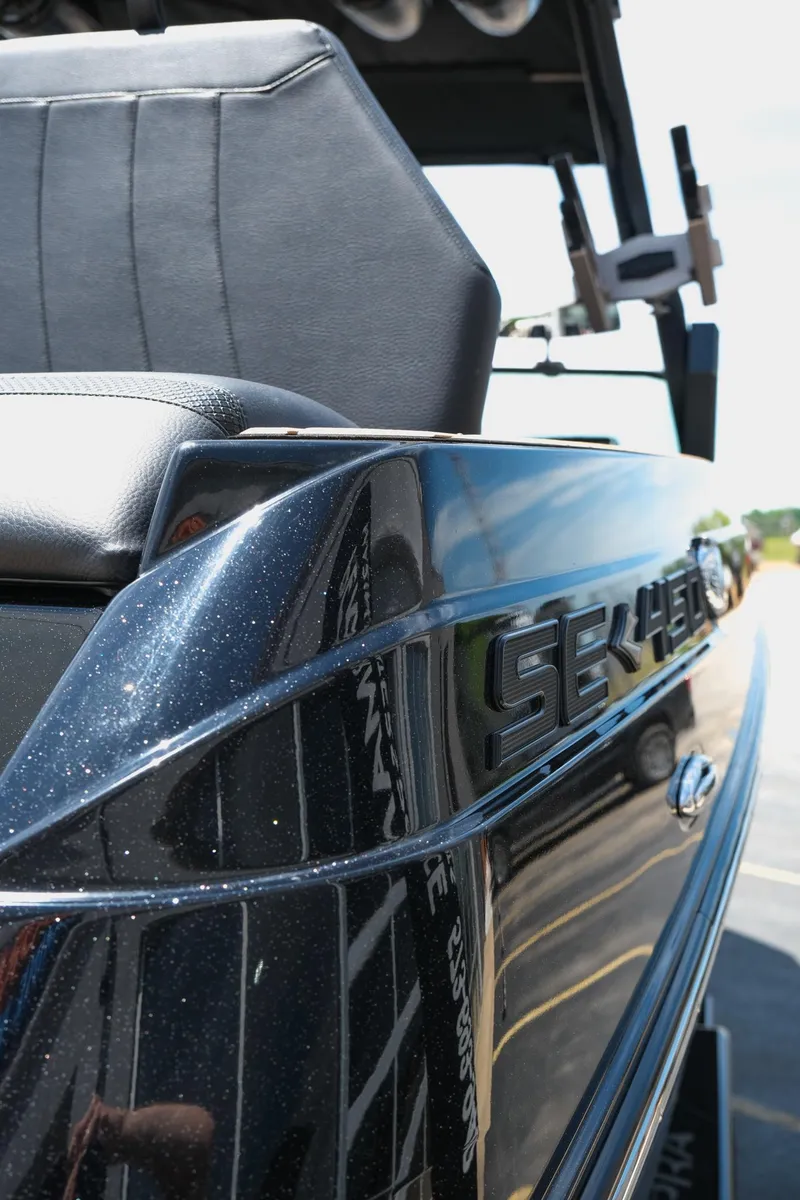 Slide: The Image of 2019 Supra SE450 boat, sleek black exterior with detailed seating. - 11