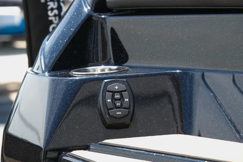 Slide: The Image of 2019 Supra SE450 boat control panel with sleek black finish and cup holder. - 12