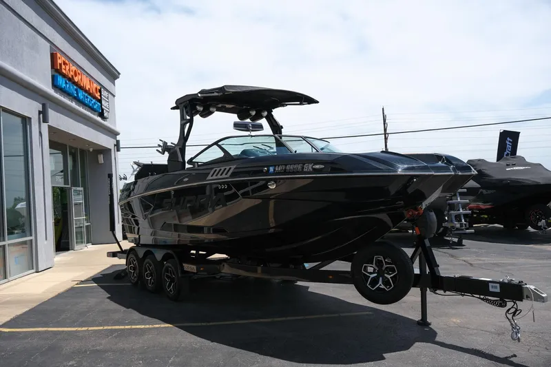 Slide: The Image of 2019 Supra SE450 boat on trailer outside dealership. - 14
