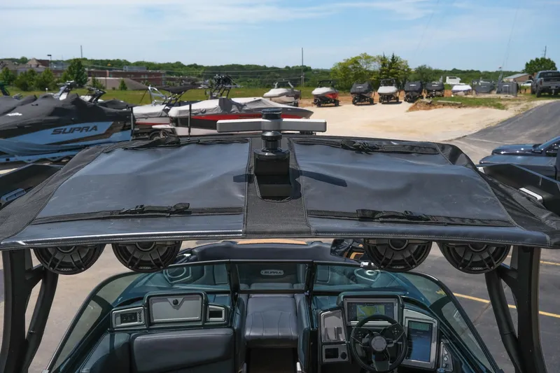 Slide: The Image of 2019 Supra SE450 boat with advanced dashboard and speakers, parked outdoors. - 17