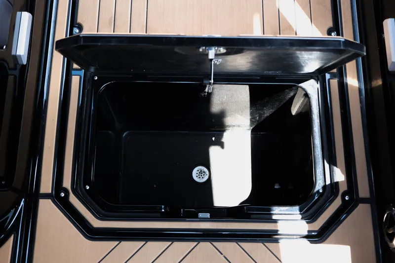 Slide: The Image of Open storage compartment on 2019 Supra SE450 boat deck. - 23