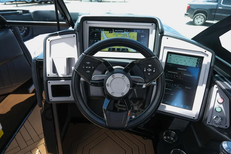 Slide: The Image of Steering wheel and dashboard of 2019 Supra SE450 boat with digital displays. - 25