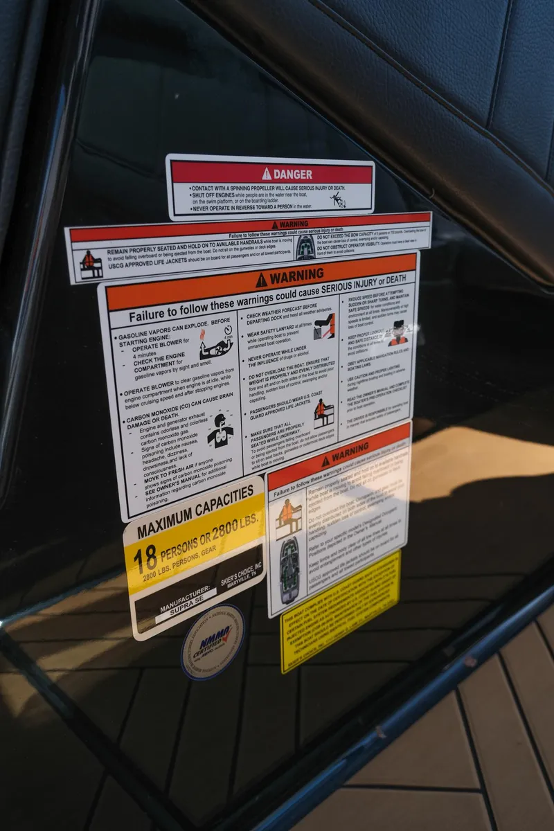 Slide: The Image of Warning labels on 2019 Supra SE450 vehicle door, detailing safety instructions and maximum capacities. - 28