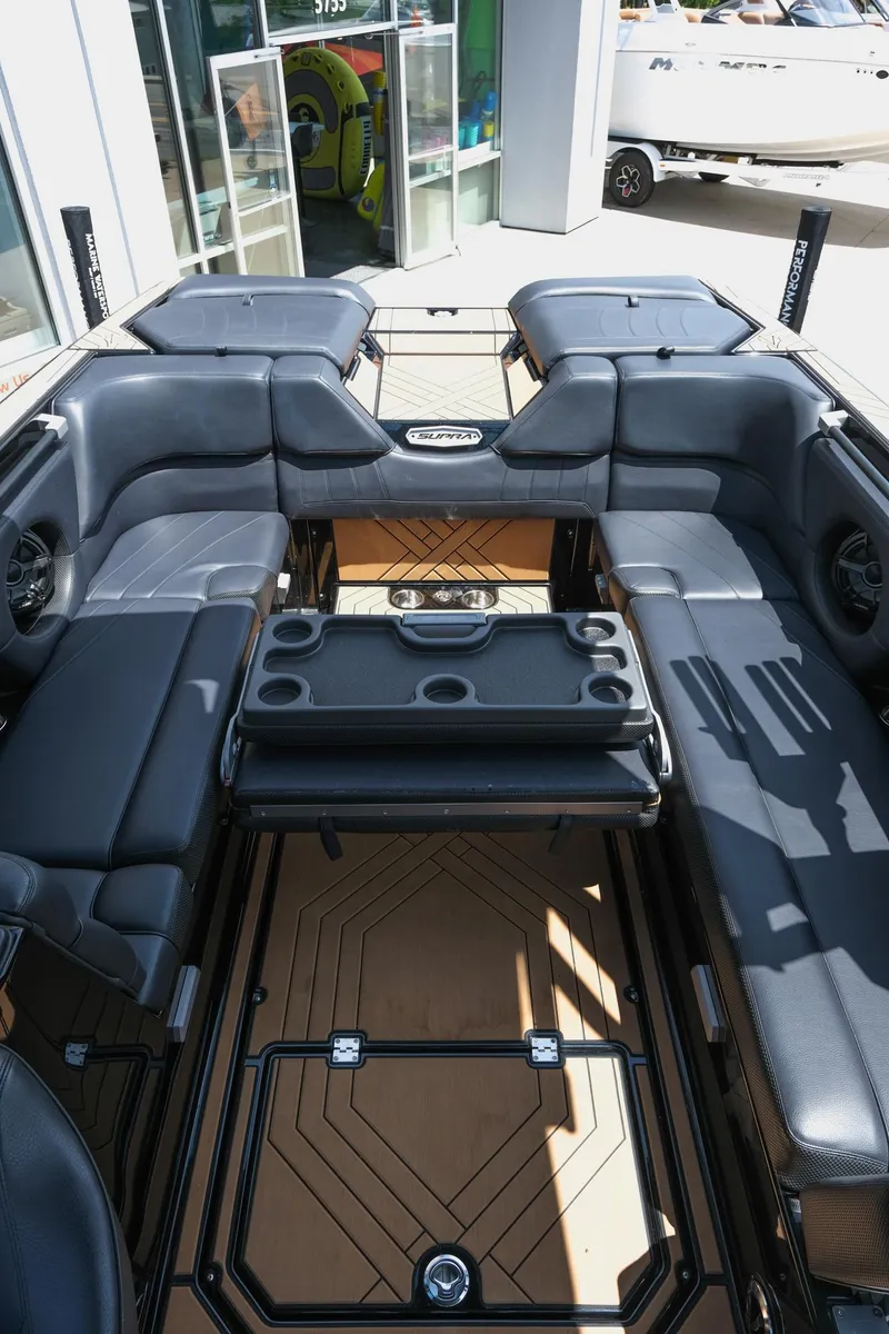 Slide: The Image of 2019 Supra SE450 boat interior with black seating and cup holders. - 37