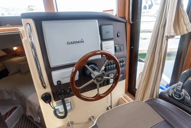 Slide: The Image of 2015 Ranger Tugs R-31 CB helm with Garmin navigation system and wooden steering wheel. - 5