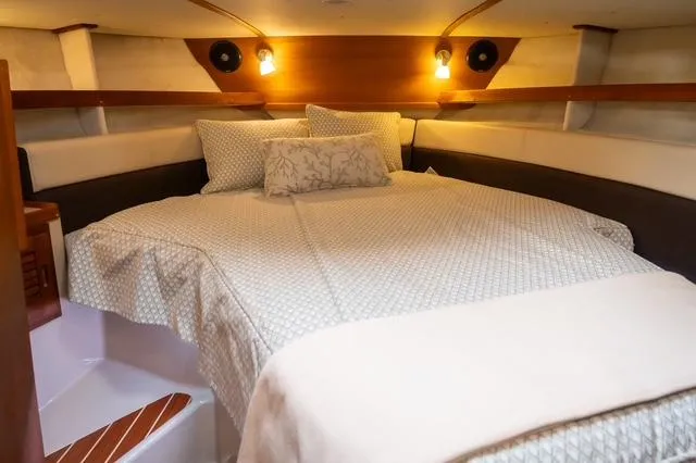 Slide: The Image of Cozy cabin interior of 2015 Ranger Tugs R-31 CB with a neatly made bed. - 6