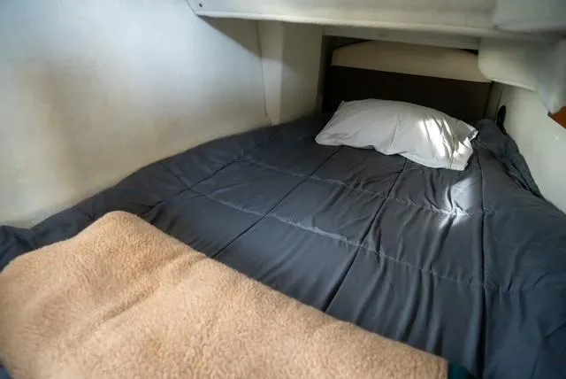 Slide: The Image of Cozy sleeping area in 2015 Ranger Tugs R-31 CB boat with bedding and pillow. - 8