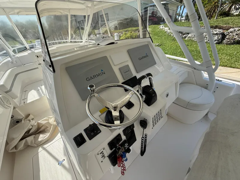 Slide: The Image of 2015 Intrepid 375 Walkaround helm with Garmin navigation system and steering wheel. - 11