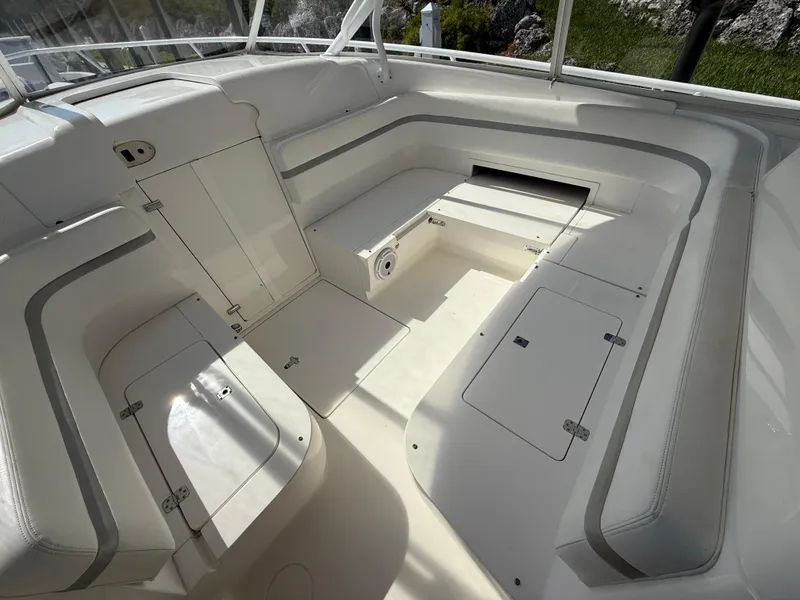 Slide: The Image of 2015 Intrepid 375 Walkaround boat interior with spacious seating and storage compartments. - 13