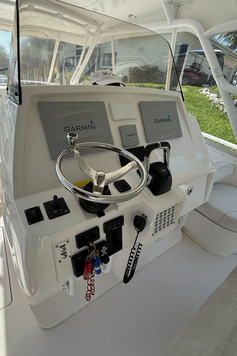 Slide: The Image of 2015 Intrepid 375 Walkaround helm with Garmin navigation system and steering wheel. - 14