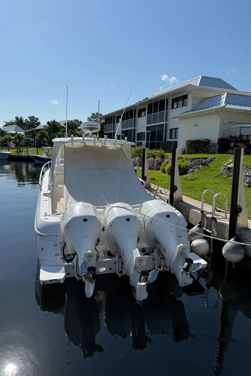 Slide: The Image of 2015 Intrepid 375 Walkaround boat docked with triple outboard engines. - 4