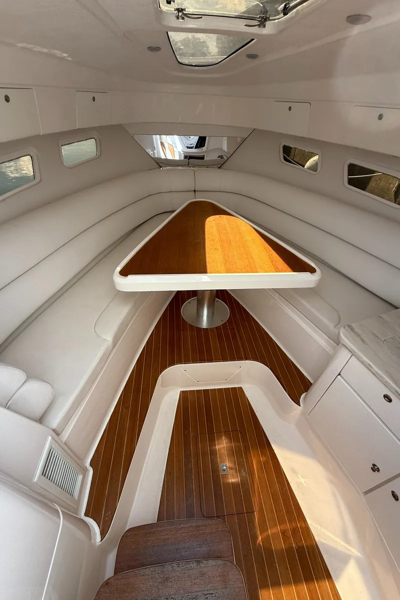 Slide: The Image of 2015 Intrepid 375 Walkaround cabin interior with wood flooring and triangular table. - 5