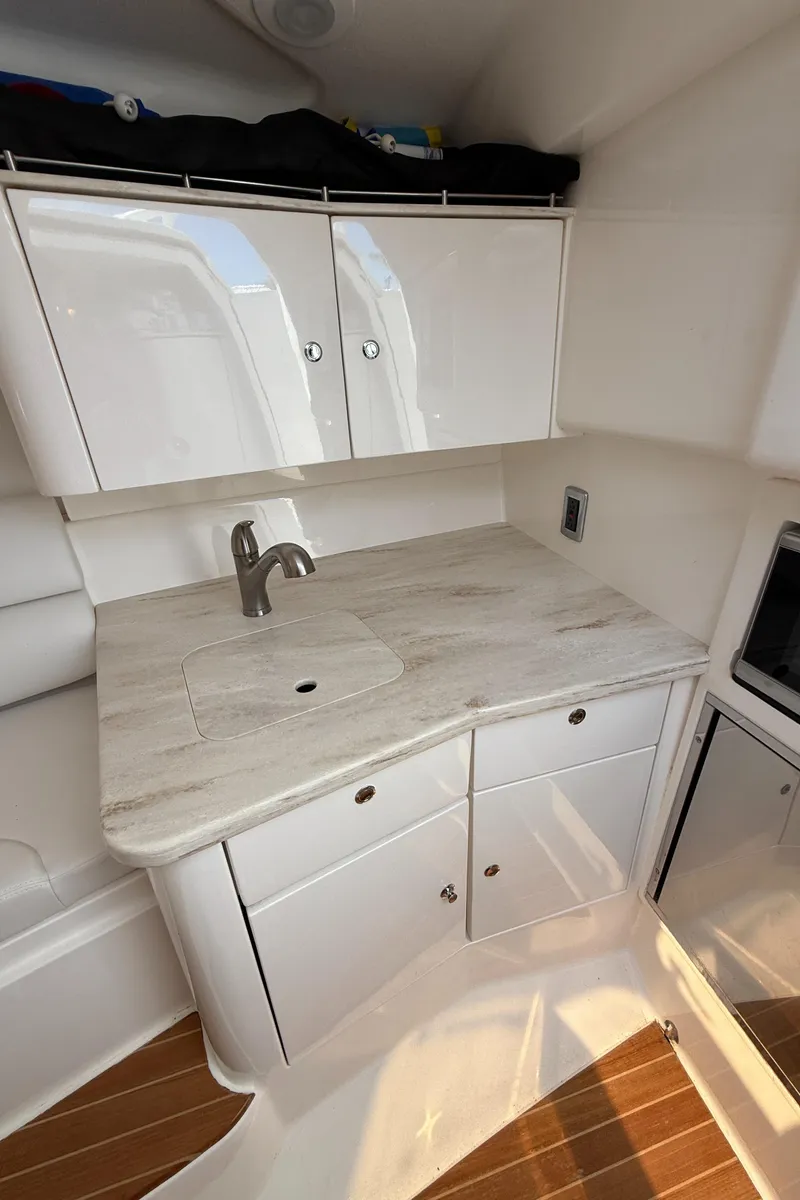 Slide: The Image of 2015 Intrepid 375 Walkaround interior with sleek white cabinetry and modern sink. - 6