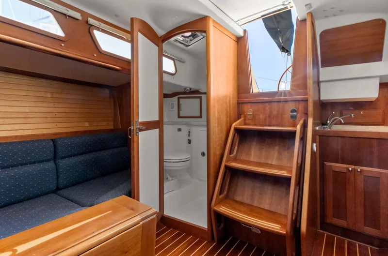 Slide: The Image of 2008 Sabre Spirit yacht interior with wooden finish, seating, and compact bathroom. - 10