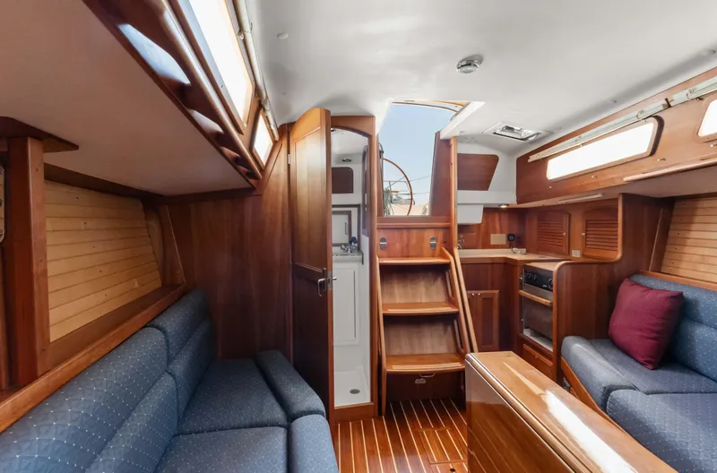 Slide: The Image of 2008 Sabre Spirit yacht interior with wooden finish and blue seating. - 11