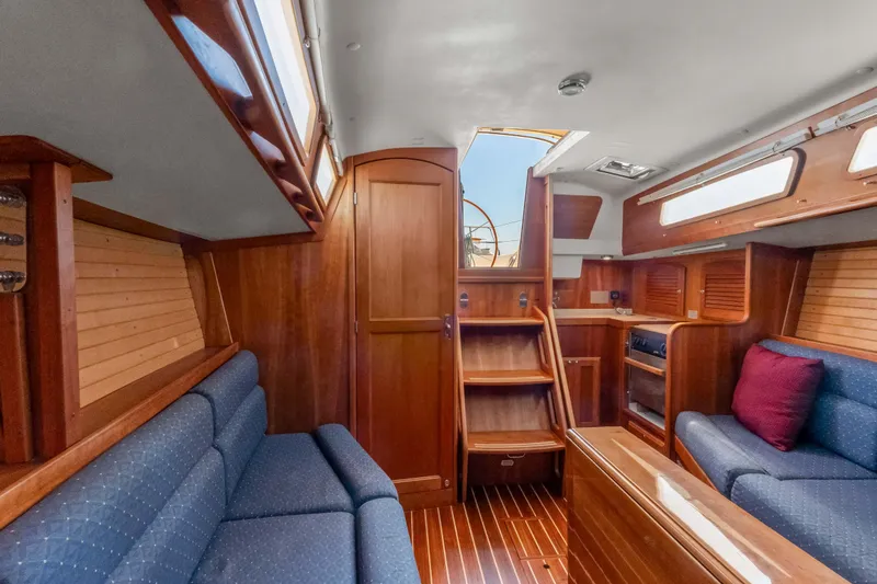 Slide: The Image of 2008 Sabre Spirit yacht interior with wooden finish and blue seating. - 13