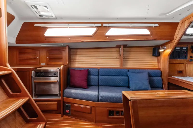 Slide: The Image of 2008 Sabre Spirit yacht interior with wooden finish, blue seating, and modern amenities. - 15