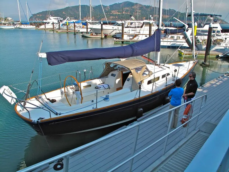Slide: The Image of 2008 Sabre Spirit sailboat docked at marina with people nearby. - 2