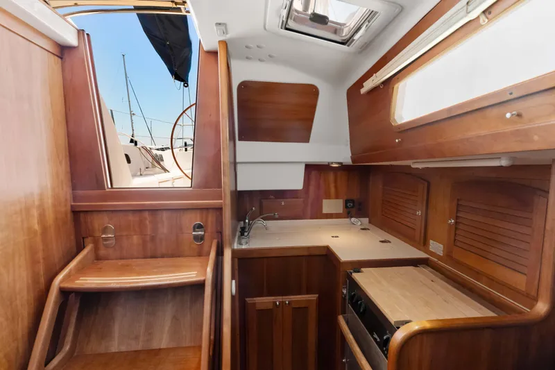 Slide: The Image of 2008 Sabre Spirit yacht interior with wooden cabinetry and compact kitchen area. - 20