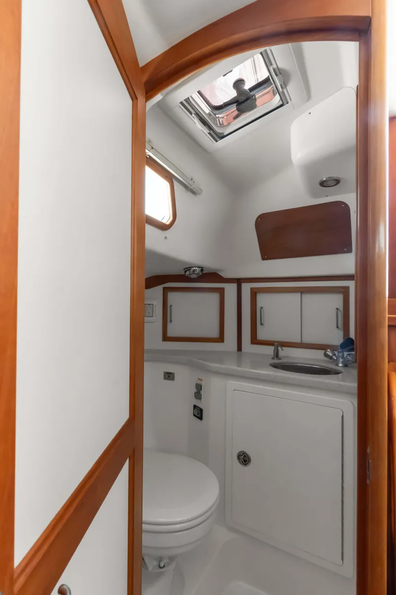 Slide: The Image of 2008 Sabre Spirit yacht bathroom with skylight, wooden trim, and compact design. - 23