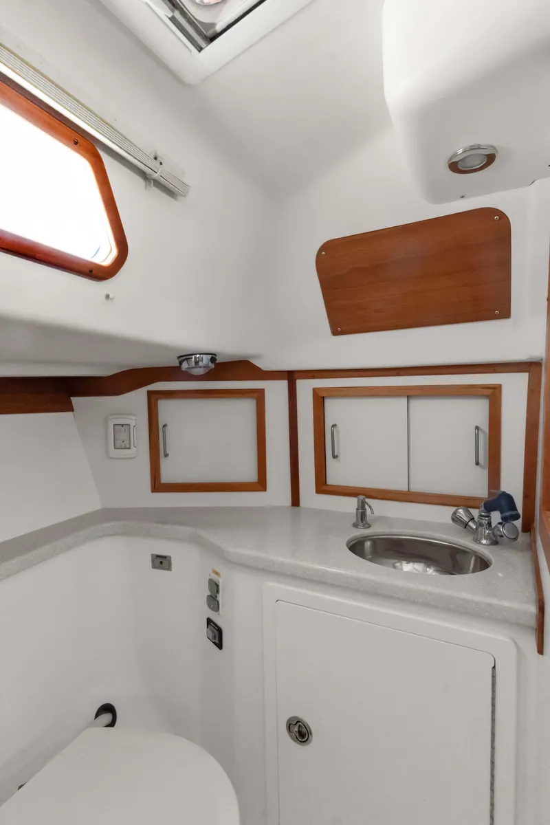 Slide: The Image of 2008 Sabre Spirit yacht bathroom with sink, storage cabinets, and modern fixtures. - 25
