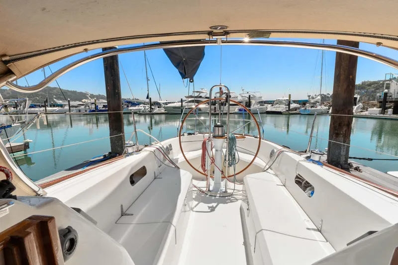 Slide: The Image of 2008 Sabre Spirit sailboat cockpit with marina view, featuring a steering wheel and seating. - 31