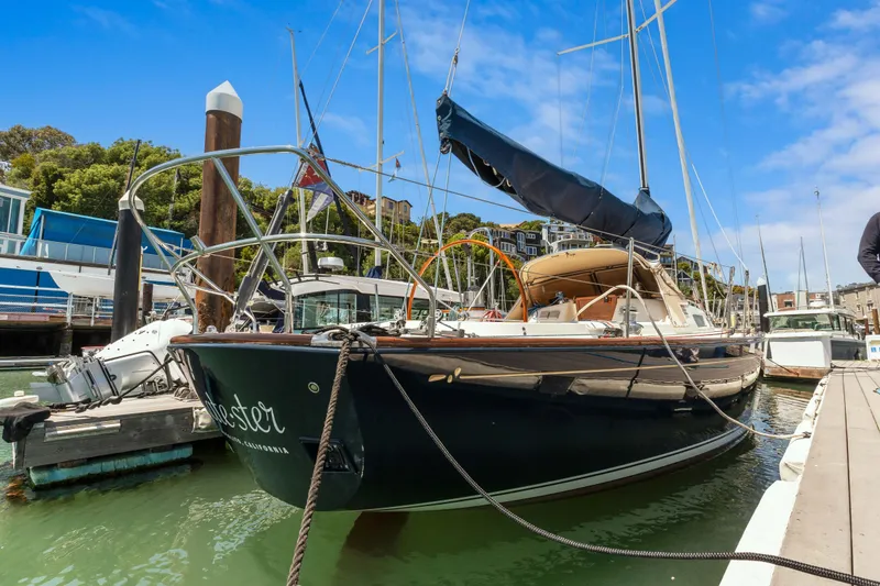 Slide: The Image of 2008 Sabre Spirit sailboat docked in marina, clear blue sky, lush greenery in background. - 37