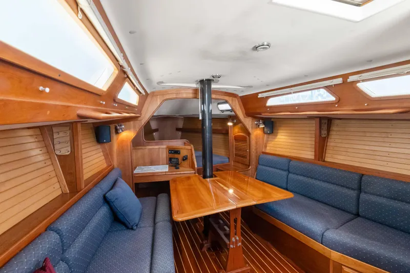 Slide: The Image of Interior of 2008 Sabre Spirit sailboat with wooden finish and blue seating. - 4
