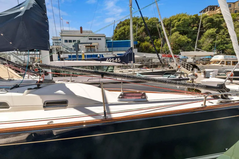 Slide: The Image of 2008 Sabre Spirit sailboat docked at a marina with surrounding boats and trees. - 40