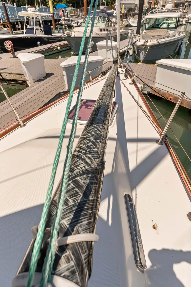 Slide: The Image of 2008 Sabre Spirit sailboat docked at marina, featuring deck and rigging details. - 42