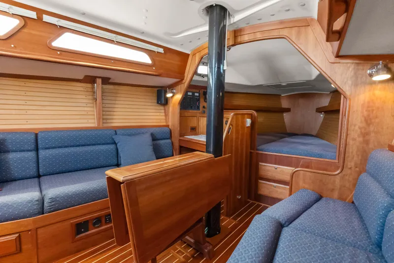Slide: The Image of 2008 Sabre Spirit yacht interior with wooden finish and blue upholstery. - 6