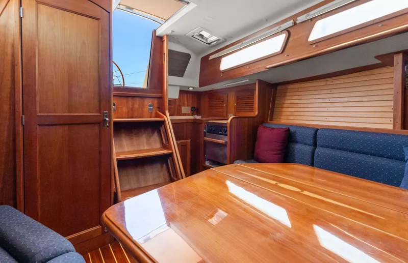Slide: The Image of Interior of 2008 Sabre Spirit sailboat with wooden finishes and blue seating. - 7