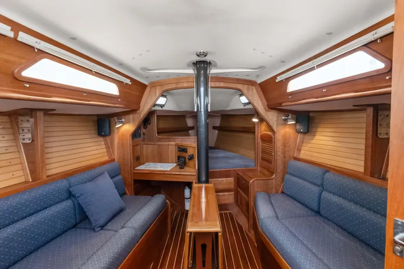 Slide: The Image of 2008 Sabre Spirit yacht interior with wooden finish and blue seating. - 9