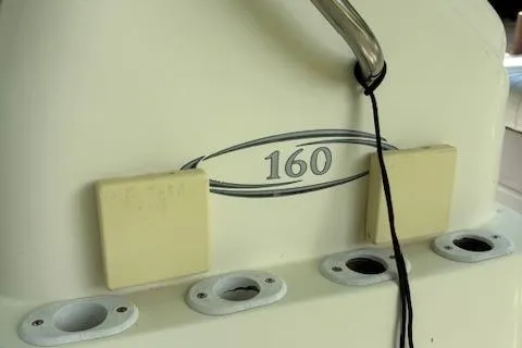 Slide: The Image of 2013 Key Largo 160 Center Console boat detail with rod holders and logo. - 10