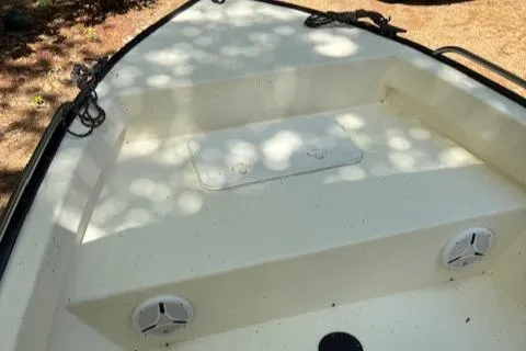 Slide: The Image of 2013 Key Largo 160 Center Console boat deck with storage compartment and speakers. - 12