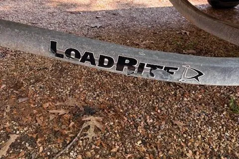 Slide: The Image of Trailer with Load Rite logo on gravel, for 2013 Key Largo 160 Center Console boat. - 6
