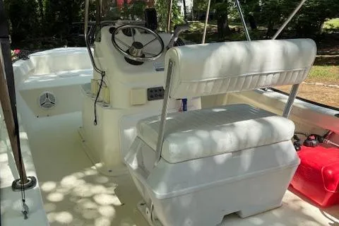 Slide: The Image of 2013 Key Largo 160 Center Console boat interior with steering wheel and seating. - 7