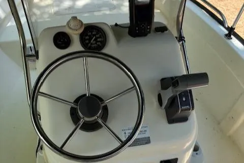 Slide: The Image of Steering console of 2013 Key Largo 160 Center Console boat with gauges and controls. - 9