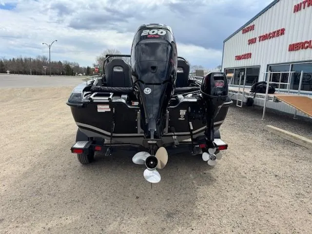 Slide: The Image of 2018 Nitro ZV18 boat with powerful engine, parked near a dealership. - 7