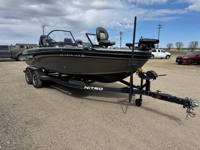 Slide: The Image of 2018 Nitro ZV18 boat on trailer in parking lot under cloudy sky. - 9