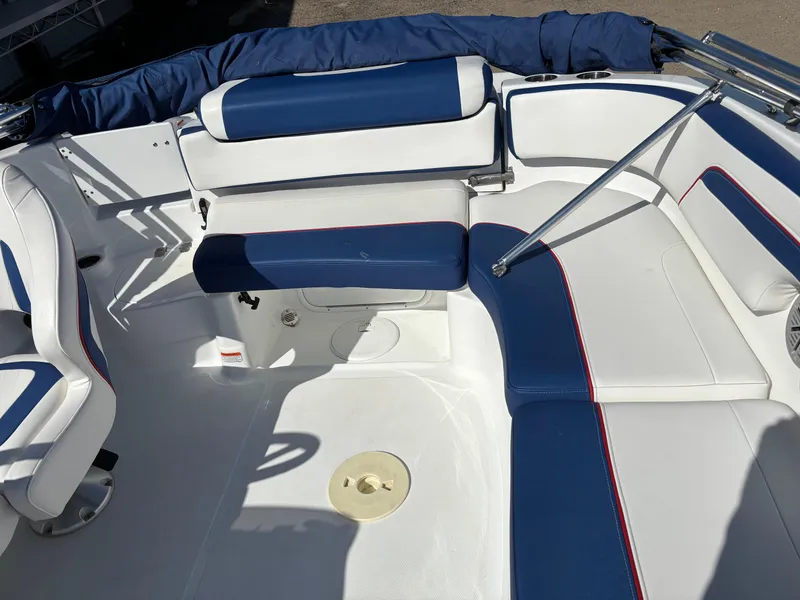Slide: The Image of 2020 Tahoe 215 Xi boat interior with blue and white seating, featuring a spacious layout. - 12
