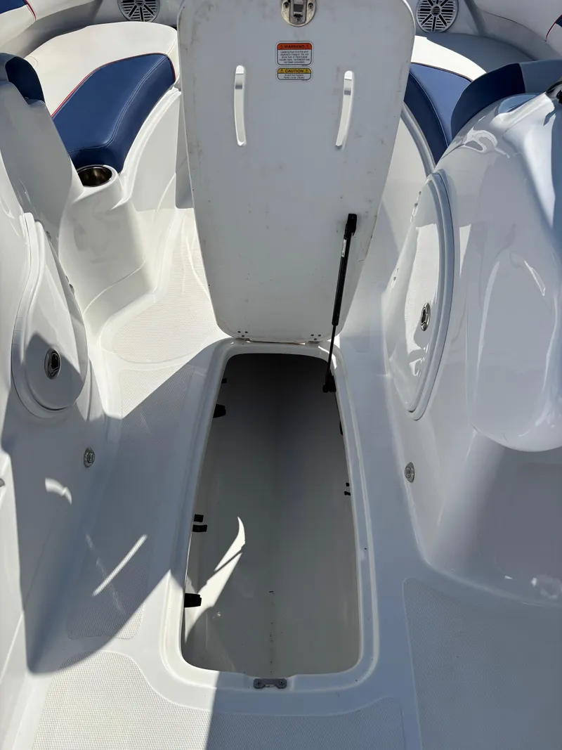Slide: The Image of 2020 Tahoe 215 Xi boat interior with open storage compartment. - 16