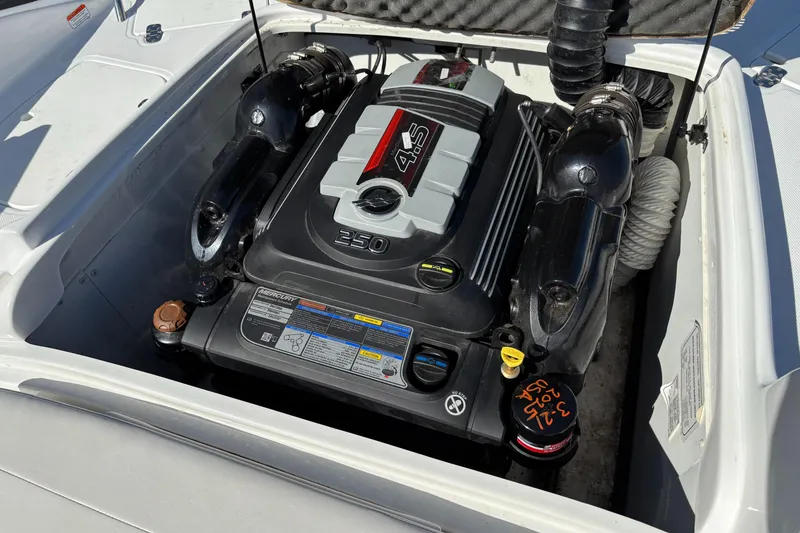 Slide: The Image of Engine compartment of a 2020 Tahoe 215 Xi boat, featuring a 4.5L engine. - 18